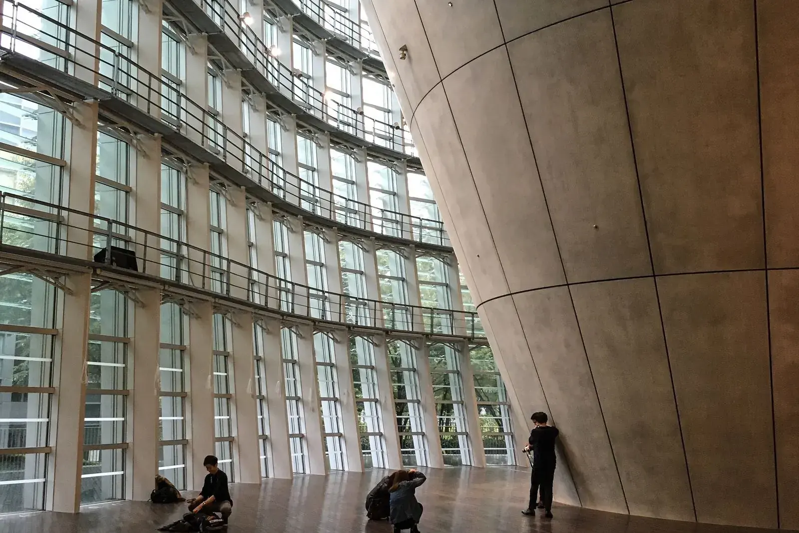 Undulating glass wall and concrete cone inside the National Art Center, Tokyo