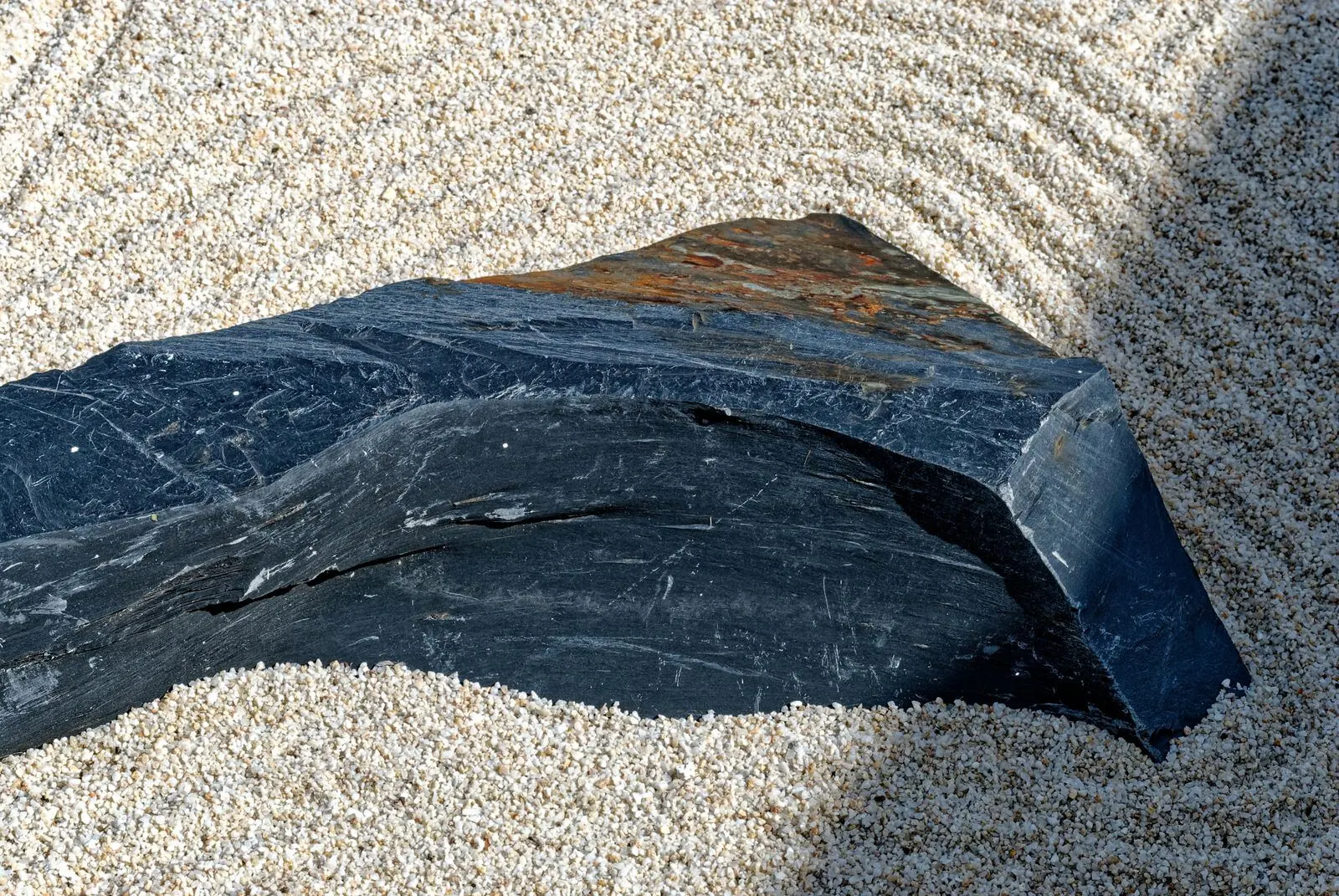 A single stone set in carefully raked gravel